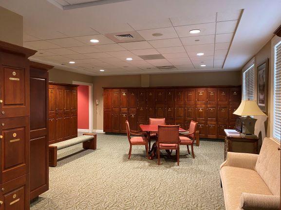 Clean and well-maintained locker room with wooden lockers and seating area
