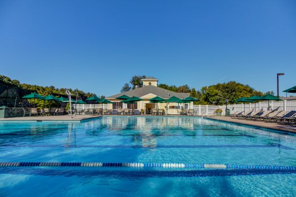 View of Charter Oak Country Club Olympic-sized swimming pool surrounded by lounge chairs