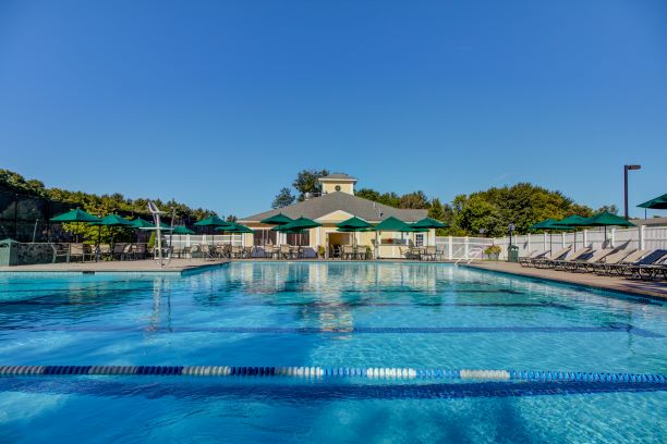 Clear, blue water swimming pool with several lounge chairs