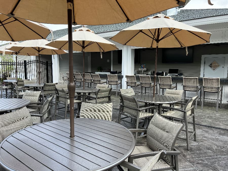 Seating area with tables, umbrellas, and chairs